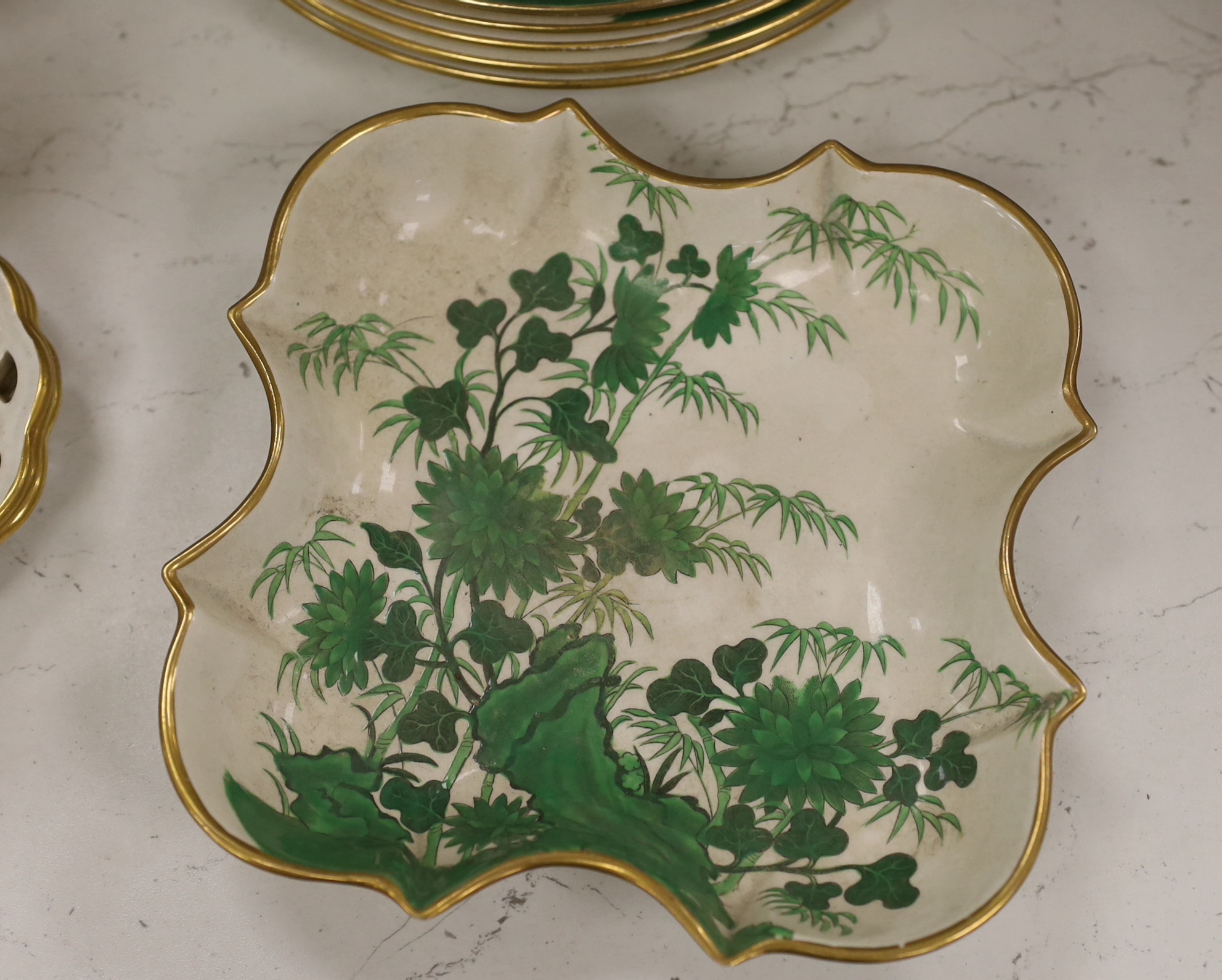 An early 19th century thirty-six piece part dessert service decorated with flowers, the largest 30cm wide
